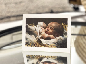 notecard with a painting of Baby Jesus sleeping in a manger