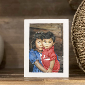 young girl in blue dress holding her little brother wearing red in El Salvador