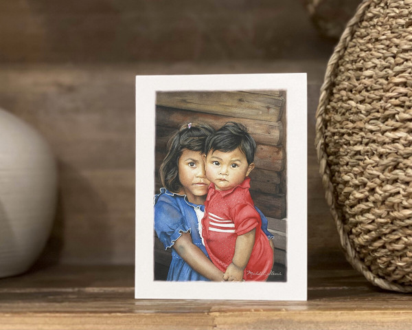 young girl in blue dress holding her little brother wearing red in El Salvador