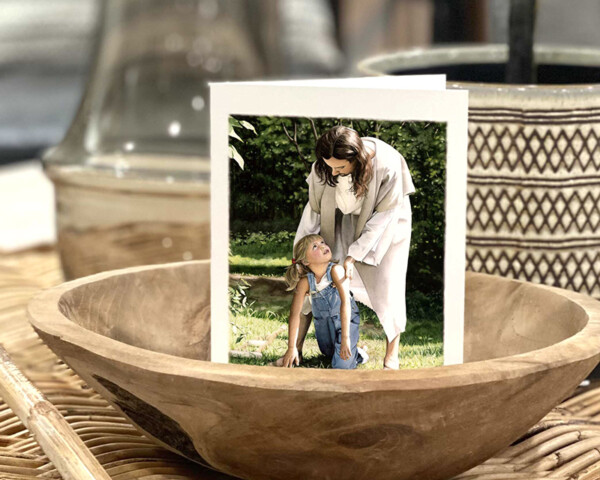 Jesus helping little girl who has fallen down