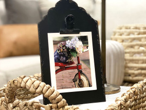 red tricycle with floral bouquet resting on the seat and handlebars