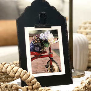 red tricycle with floral bouquet resting on the seat and handlebars