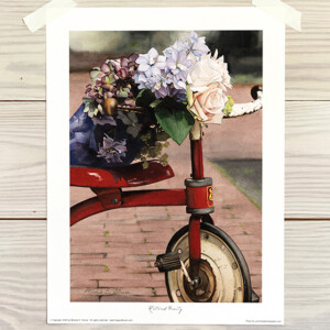 red tricycle with floral bouquet resting on seat and handles