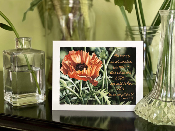 A notecard with a painting of an orange poppy flower and Luke !:45