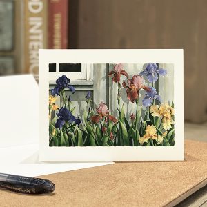 A card with a watercolor of an iris garden alongside a barn