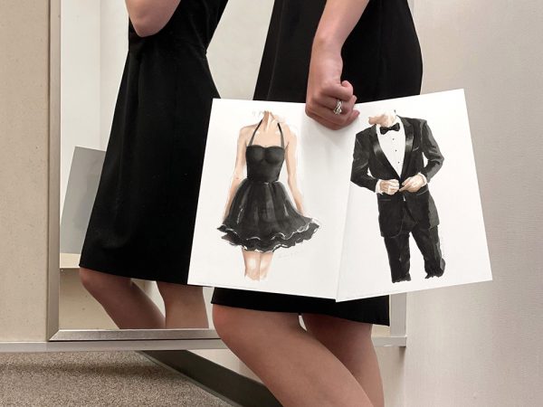 Lady holding two watercolor art prints of a lady in a little black dress and a man in a tuxedo