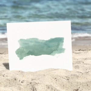 art print of turquoise paint strokes on a while background staged on a beach