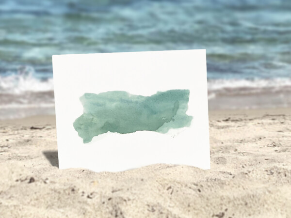 art print of turquoise paint strokes on a while background staged on a beach