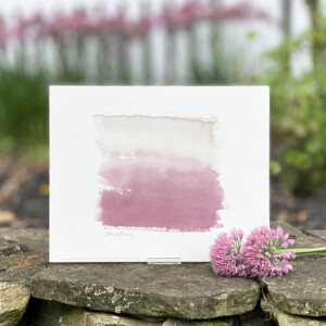 An abstract art print of watercolors blending from light gray to deep plum