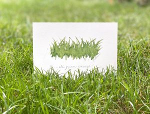 A small art print of painted grass with handwriting that says, "...it's green enough"